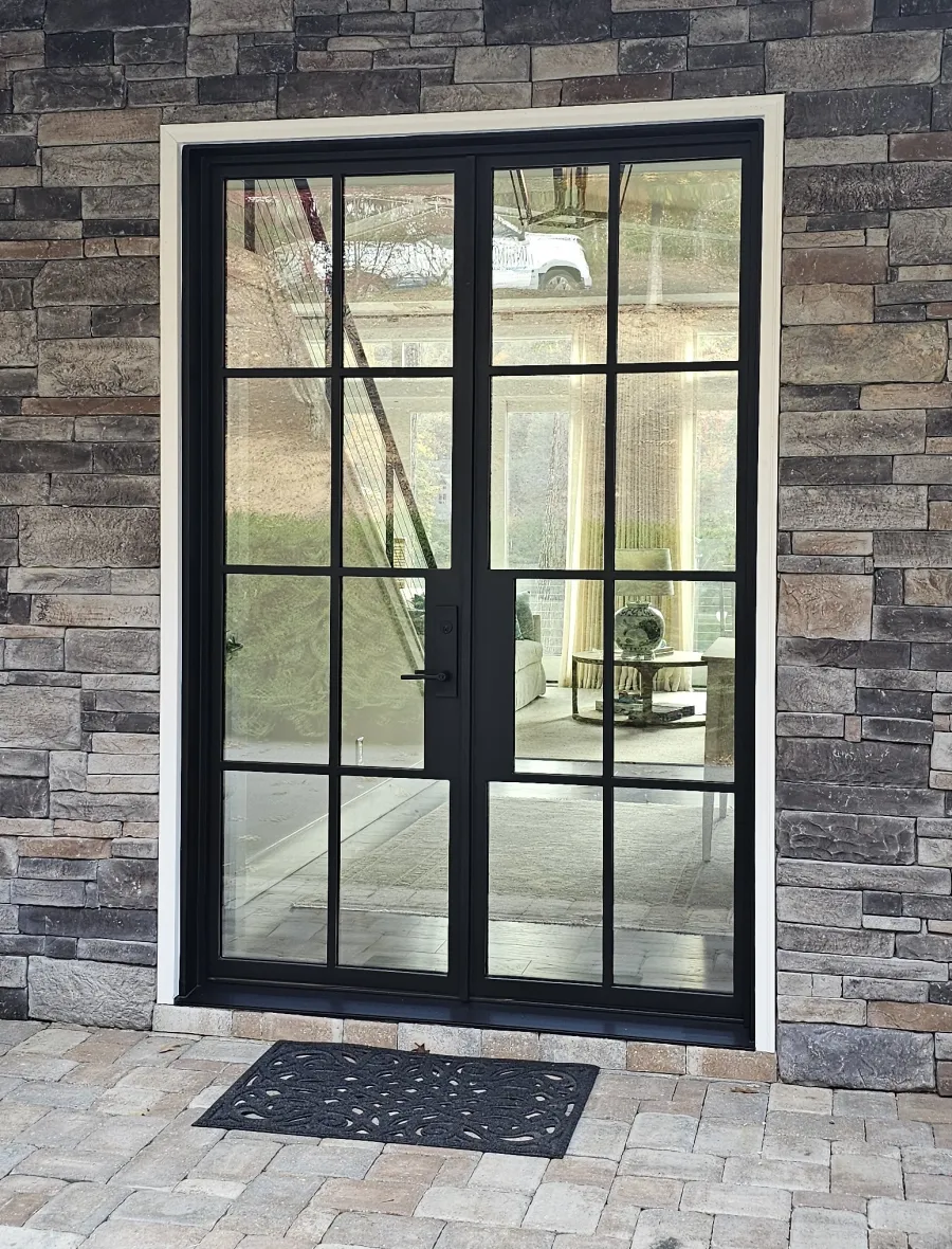 Custom black  iron front entry door with glass lites installed for a modern home in Nashville TN