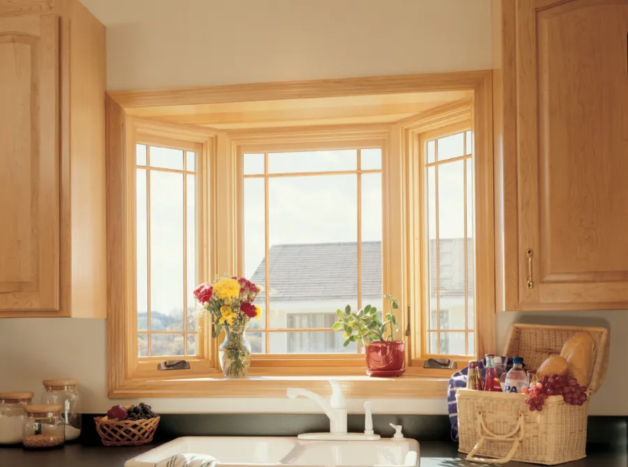a kitchen with a sink below a bay window