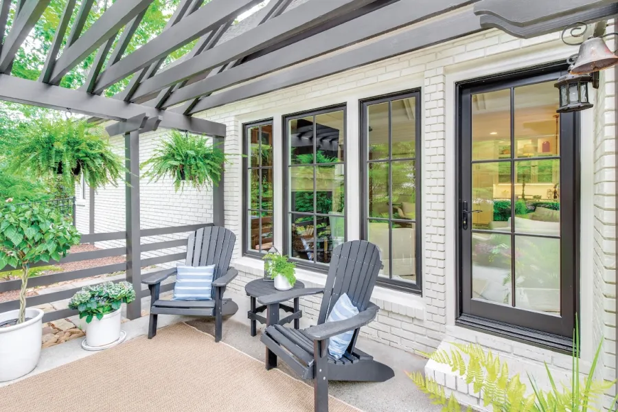 a patio with chairs and a table
