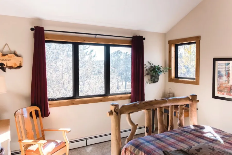 a bedroom with a bed and a window