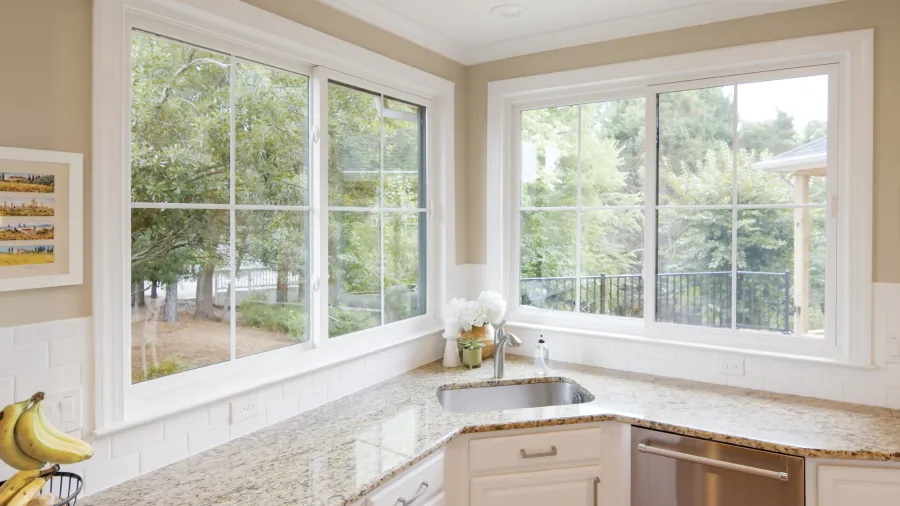 a kitchen with 2 large slider windows over the sink