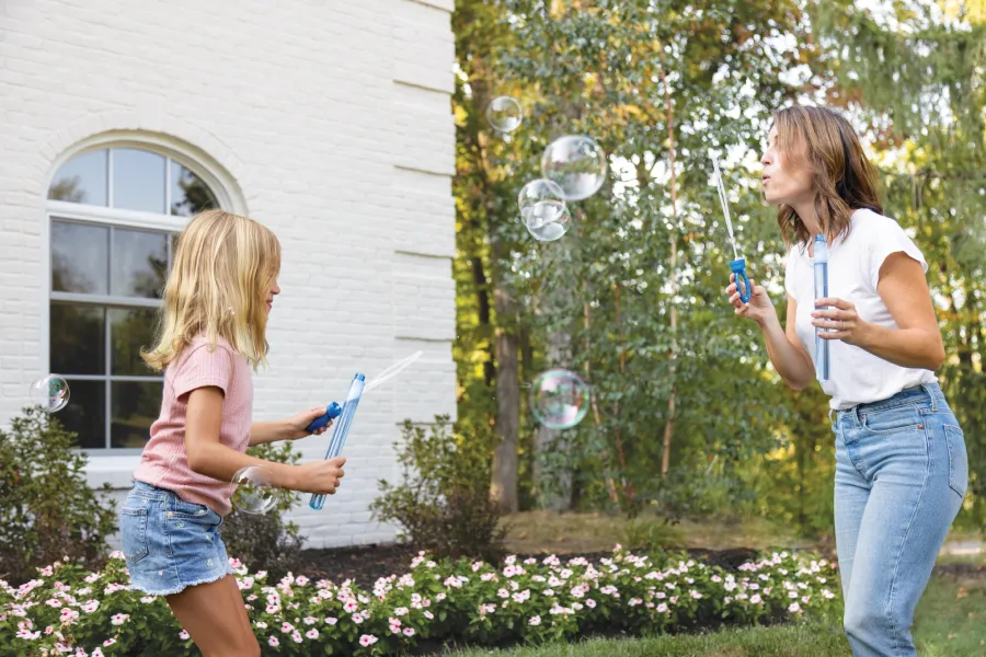a woman and a girl looking at a cell phone
