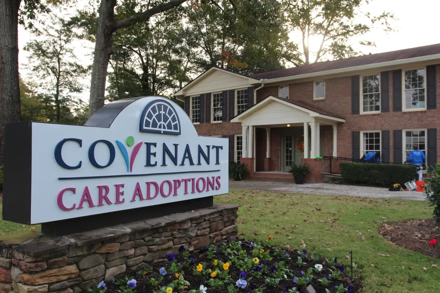 a sign in front of a house