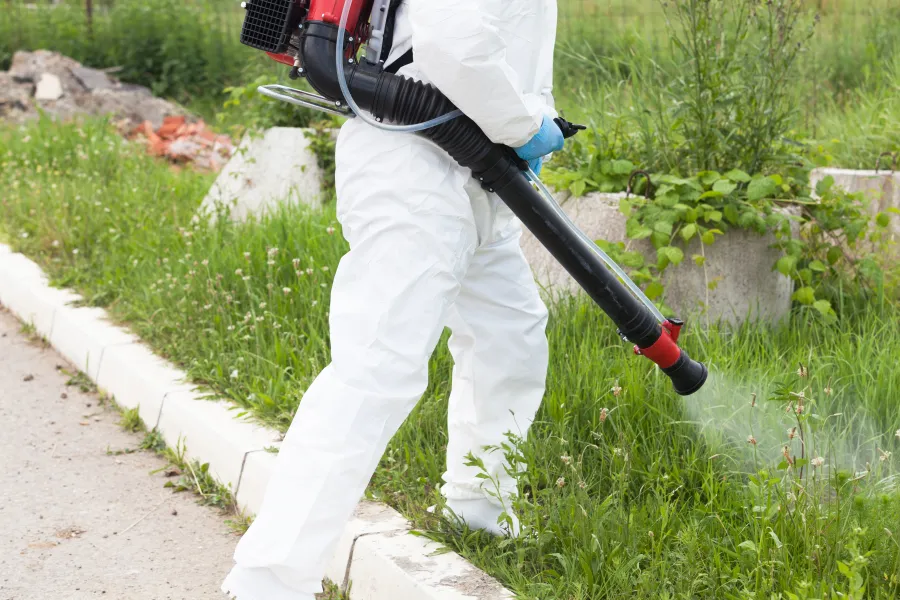 a person in a white suit holding a gun