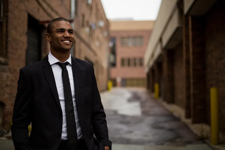 Miguel Cotto in a suit smiling