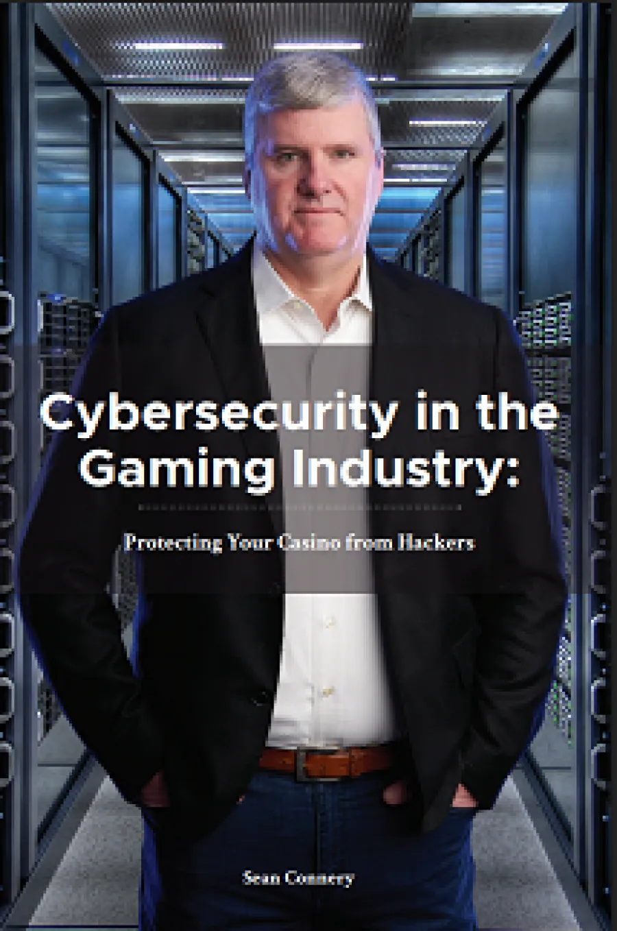 Man in blazer stands in server room with text on cybersecurity in the gaming industry overlayed.