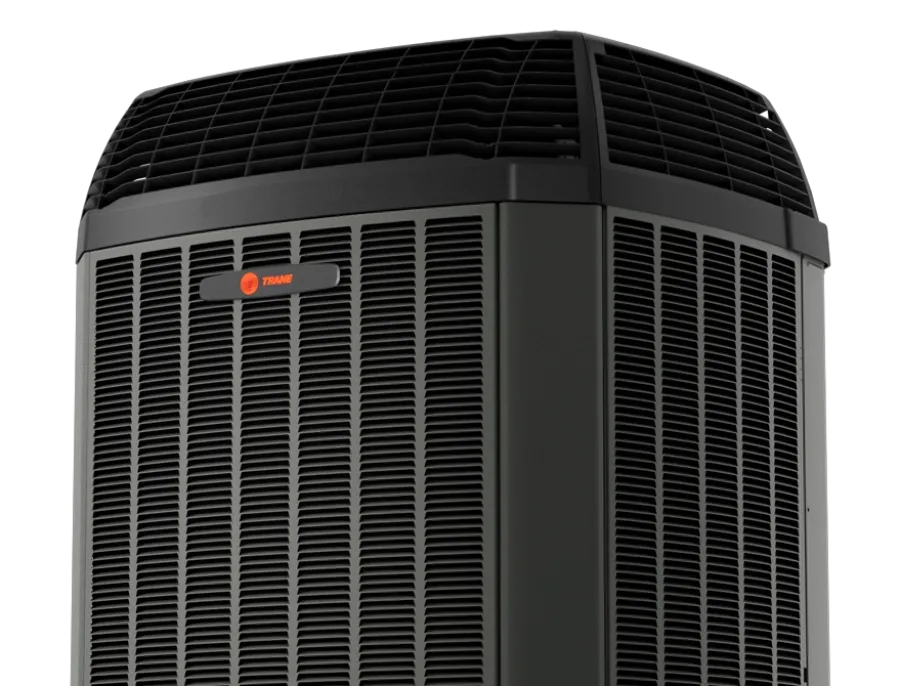 Close-up of a black Trane air conditioning unit with ventilation grills and top fan against black background