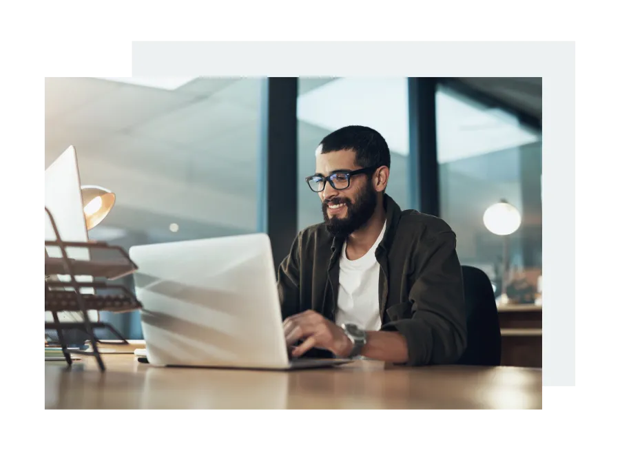 a man sitting at a table with a laptop