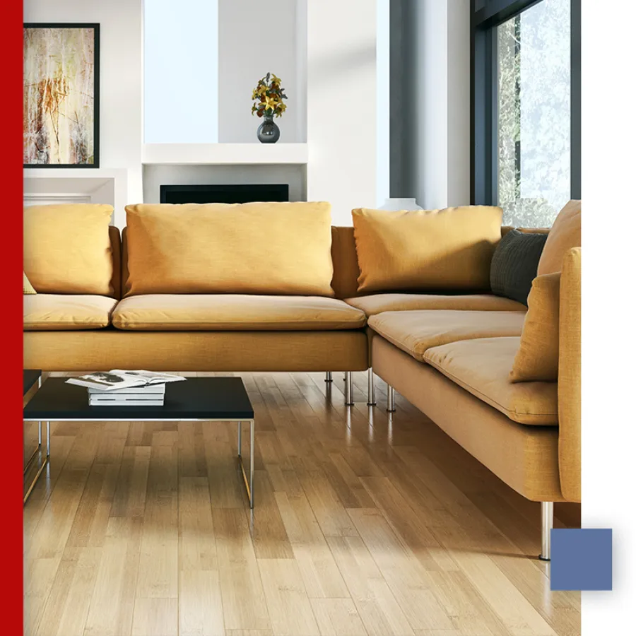 Modern living room with a mustard yellow sectional sofa, black coffee table, and hardwood floors under natural light.