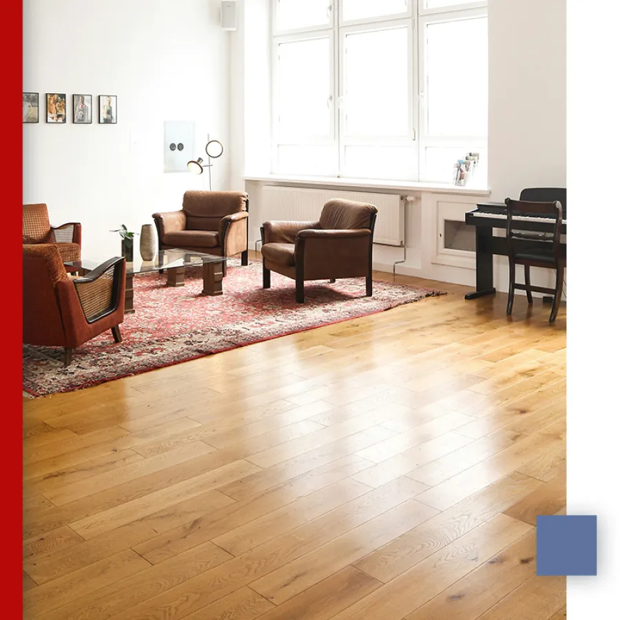 Close-up of polished hardwood floor with natural wood grain and warm tones in varied plank patterns.