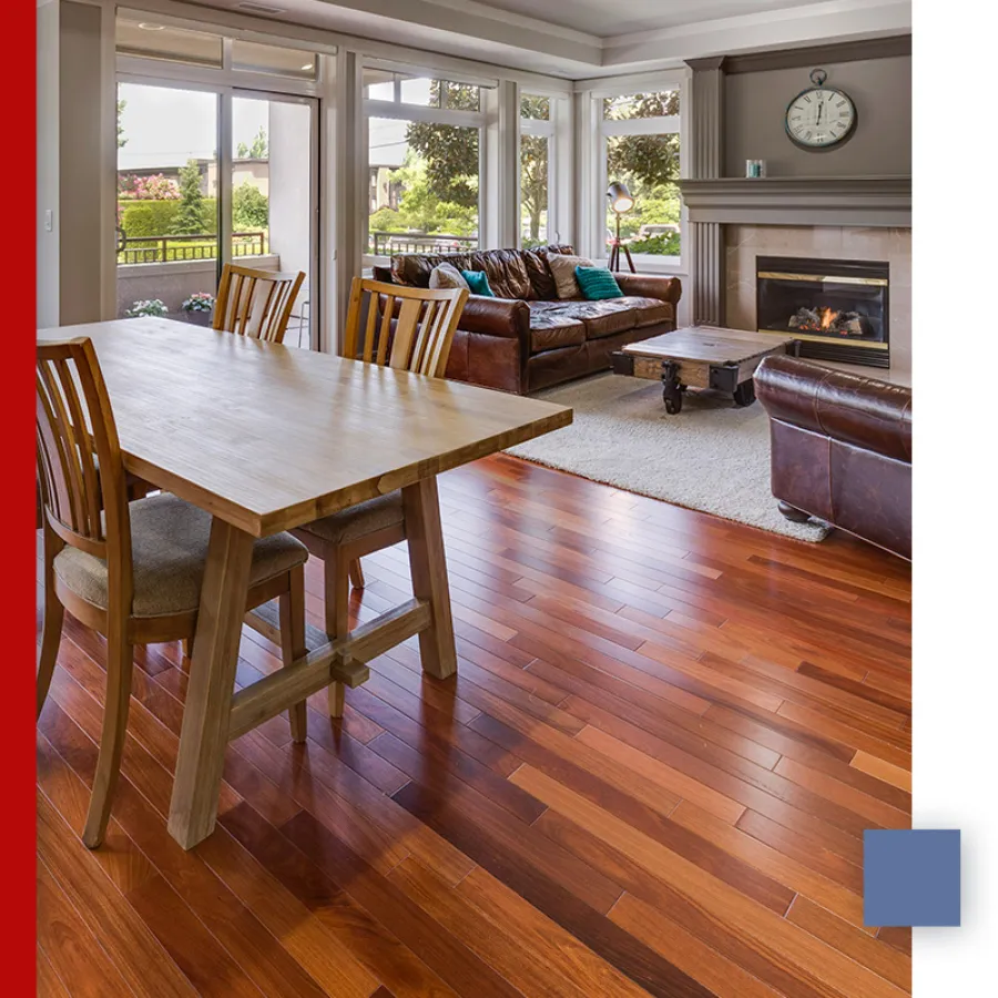 Close-up of polished wooden floorboards with natural grain and warm honey tones in a room.