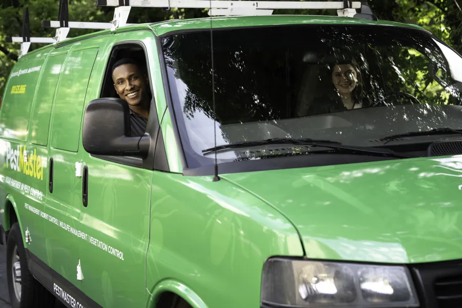 a green van with a couple of people in it