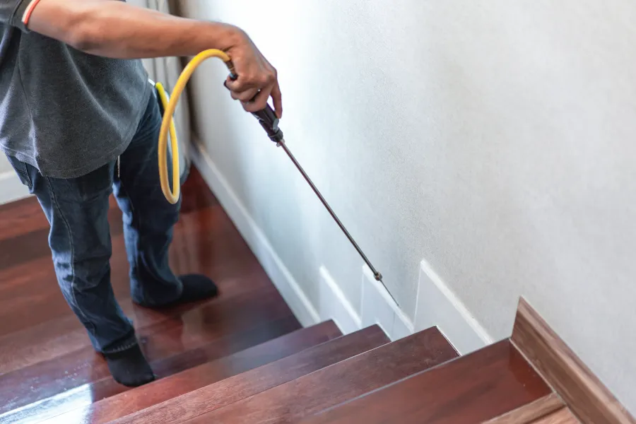 a man holding a yellow hose