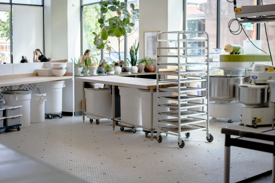 a kitchen with a table and shelves