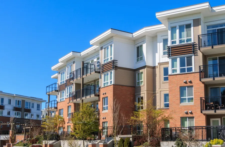 a building with balconies and trees in front of it