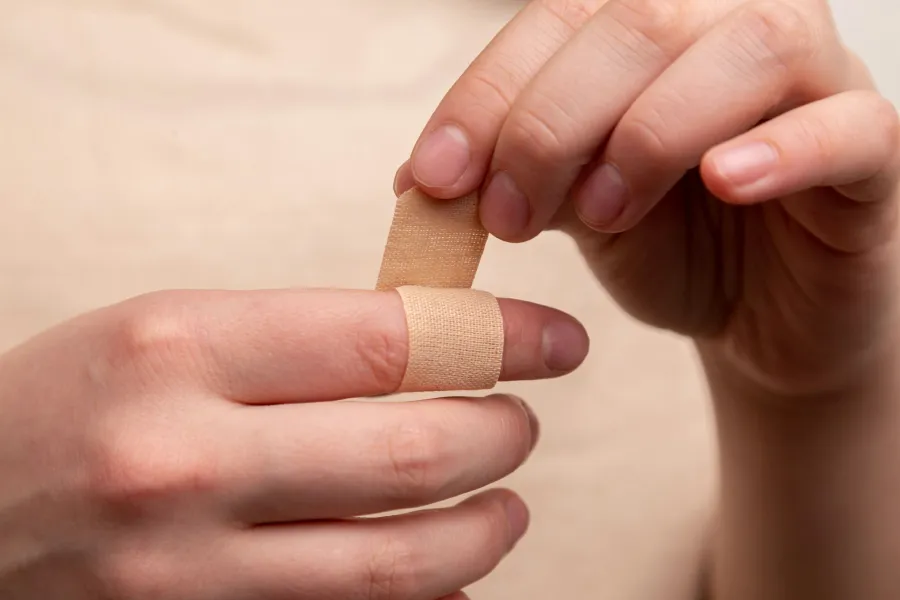 a close-up of a person's hand holding a small wooden object