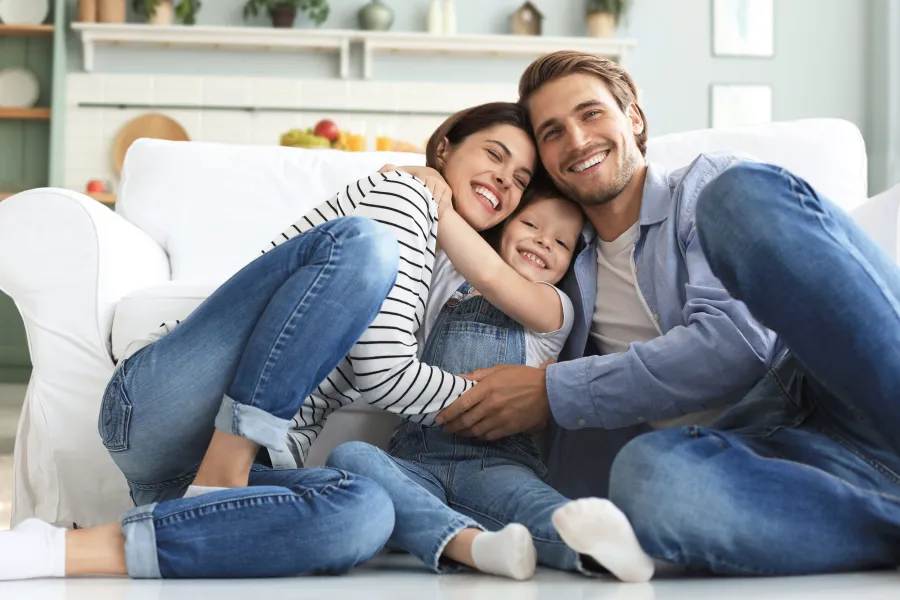 a man and woman sitting on a couch and smiling