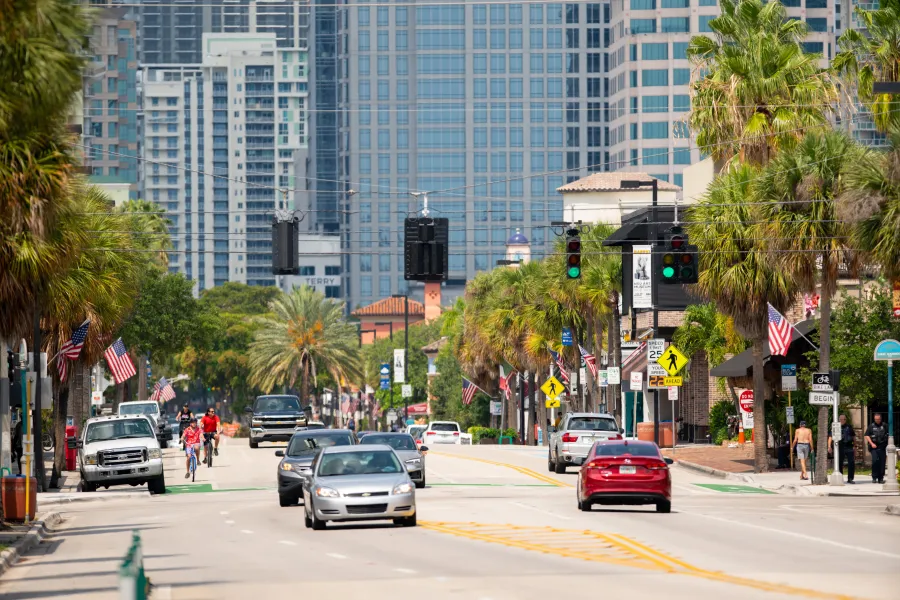 a busy street with cars and people