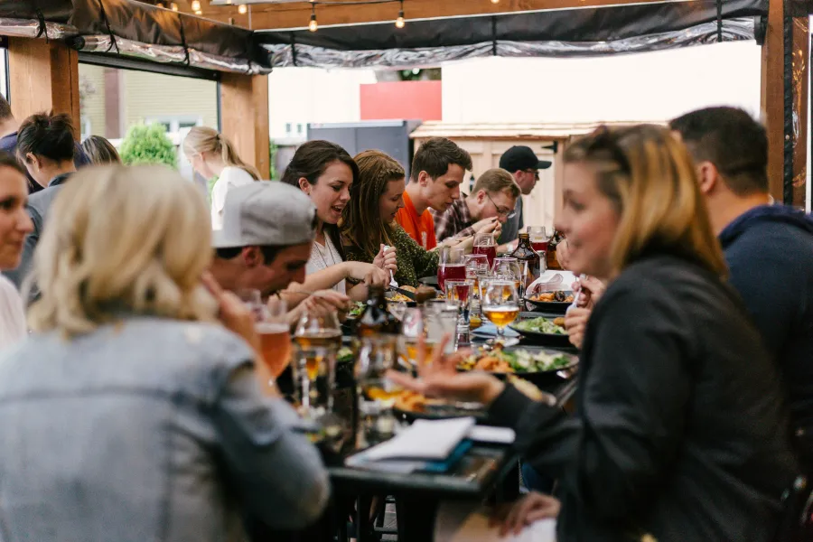 a group of people eating at a restaurant