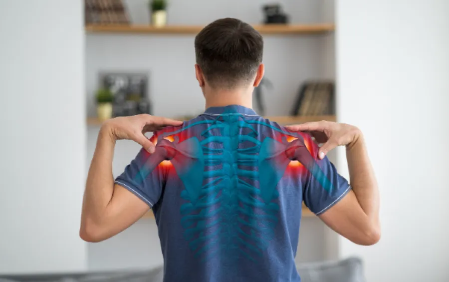 Man showing shoulder pain with highlighted areas and shoulder bones overlay for arthroscopy treatment info.