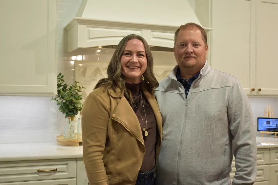 a man and a woman standing in a kitchen