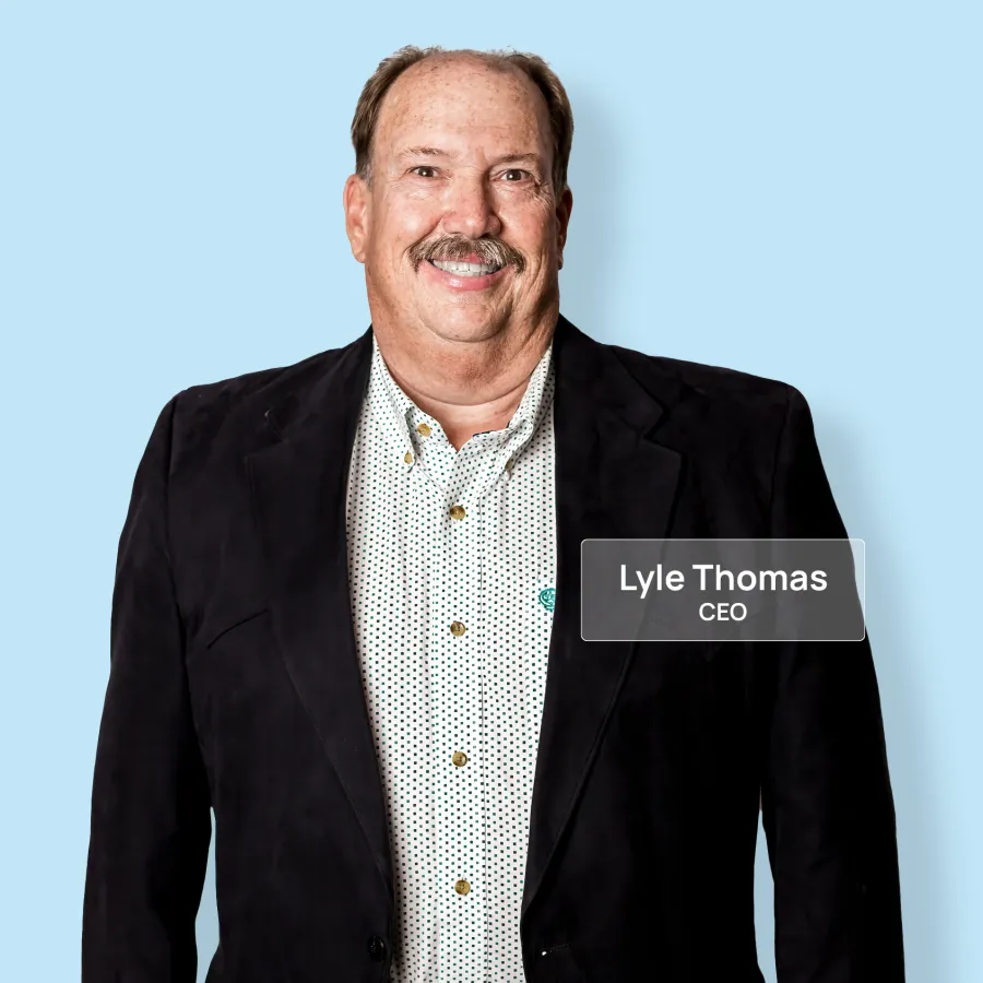 Smiling middle-aged man in dark blazer and patterned shirt on light blue background with CEO title overlay