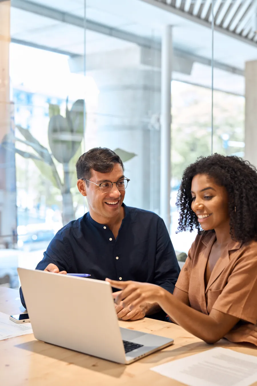 a man and a woman looking at a laptop