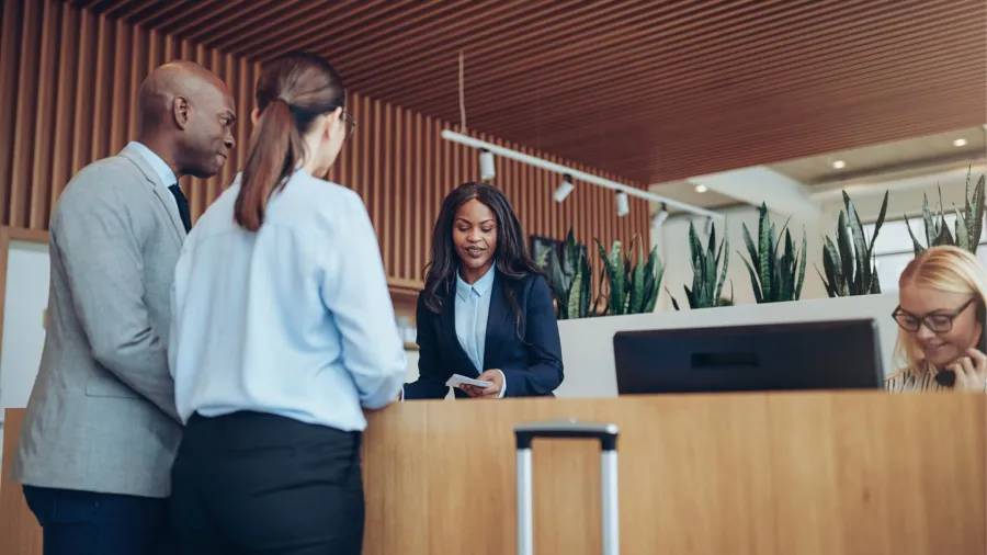 a group of people standing at a desk