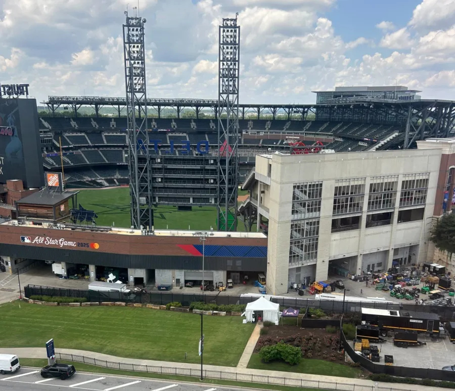 Empty Truist Park baseball stadium with All Star Game 2025 signage and clear blue sky above.