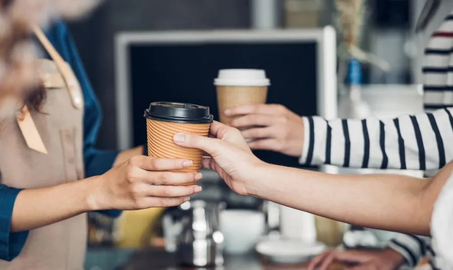 a group of people holding cups