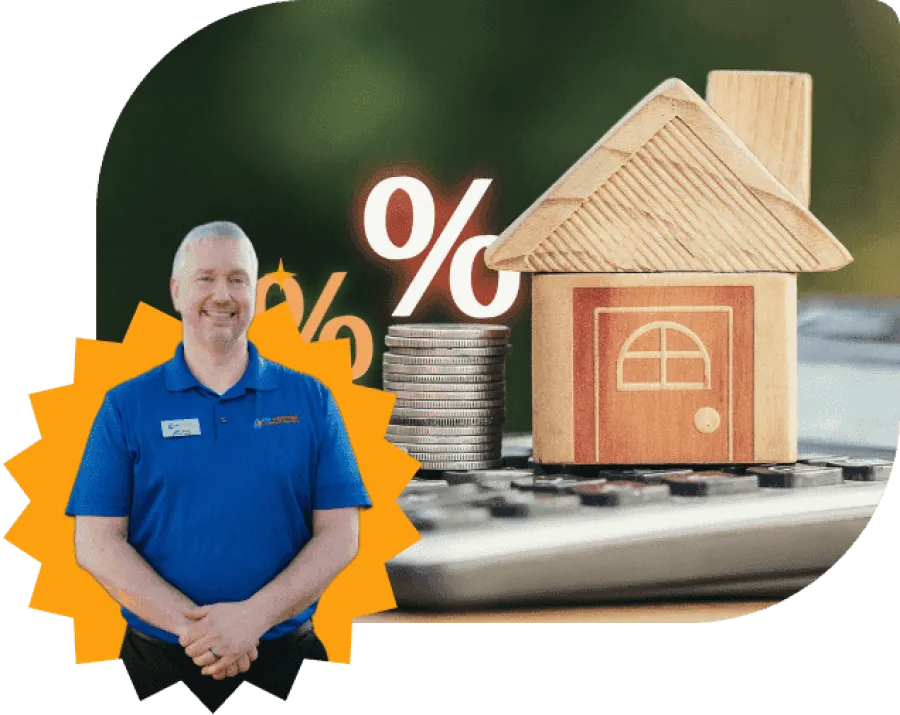 Wooden house model, stacked coins with percentage symbols, calculator, and man in blue shirt, financial concept.