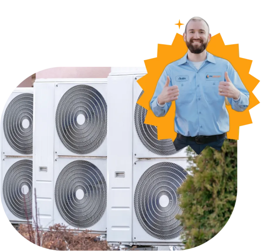 HVAC technician gives thumbs up next to rows of outdoor air conditioning units installed outside a building