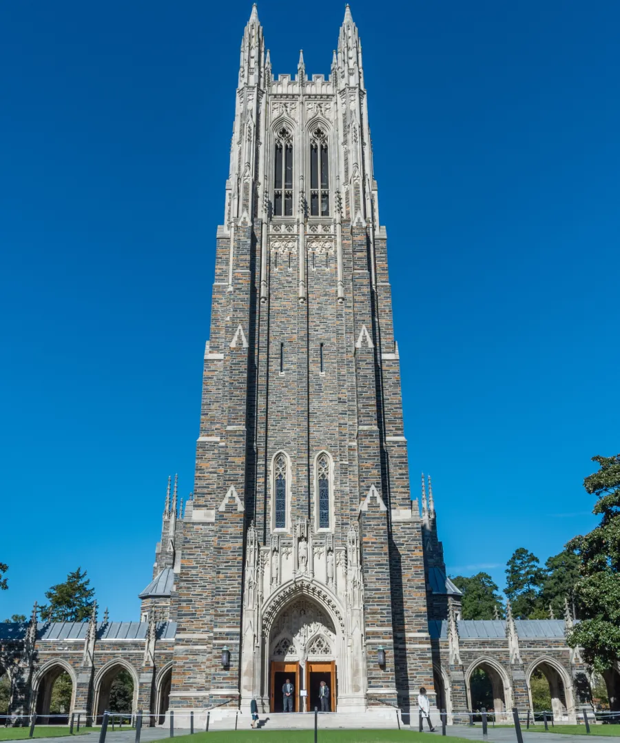 a tall stone building with Duke Chapel in the background