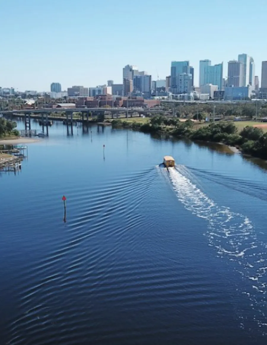 a body of water with a city in the background