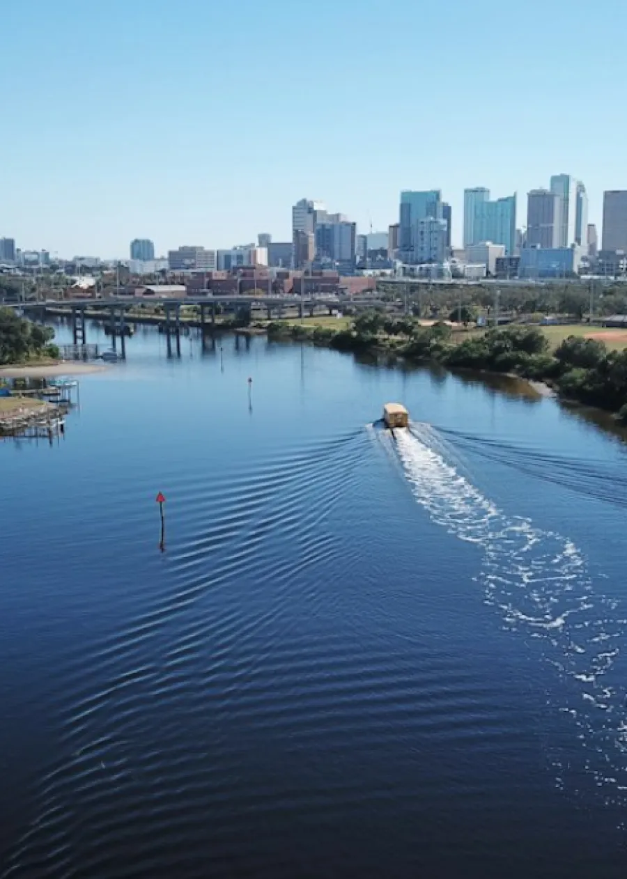 a body of water with a city in the background