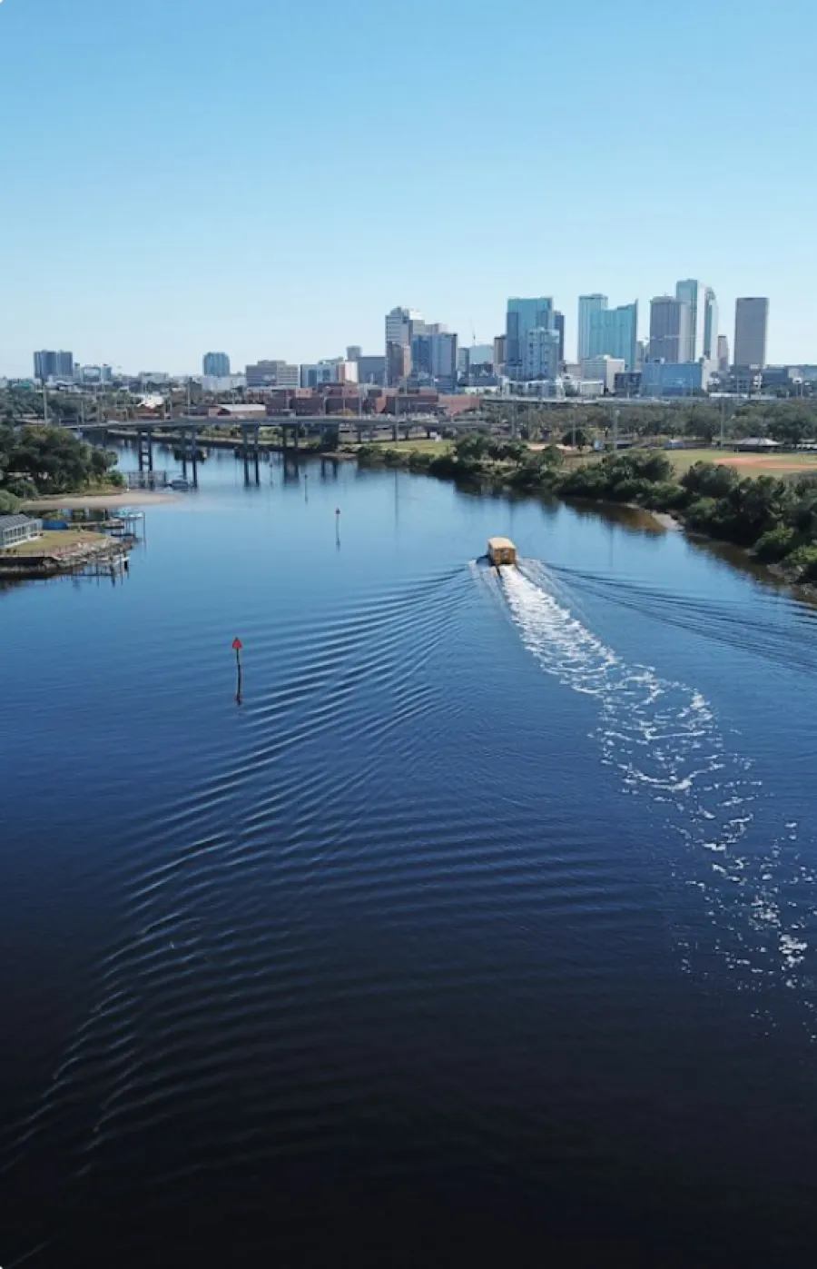 a body of water with a city in the background