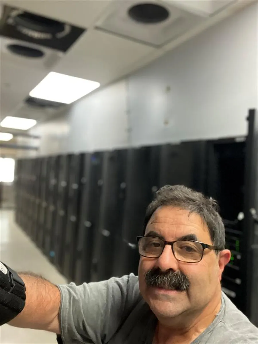 a man with glasses taking a selfie