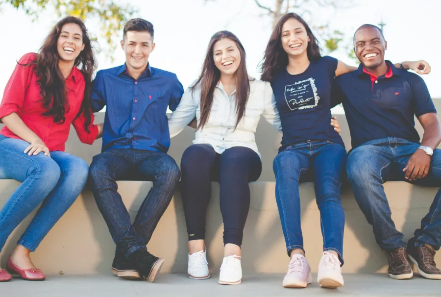 a group of people sitting together smiling