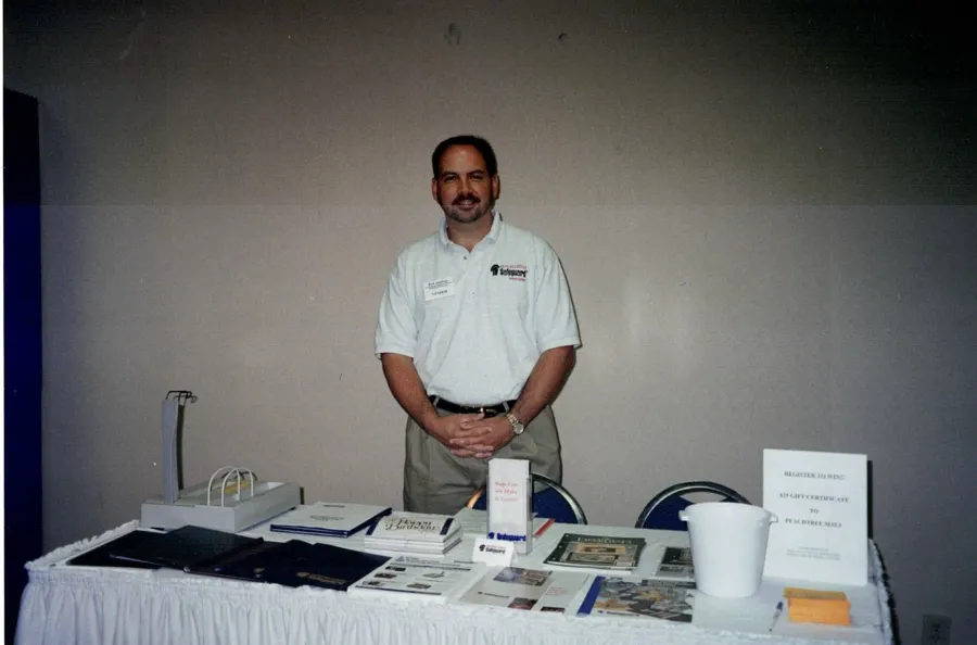 a man standing next to a table