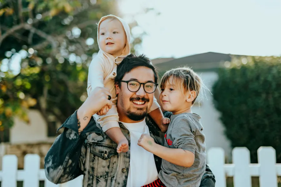 a person holding a couple of children