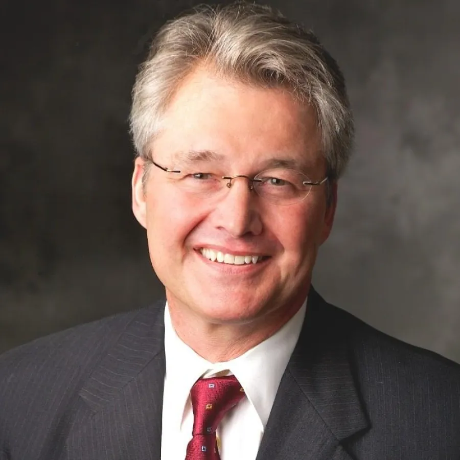 a man wearing glasses and a suit