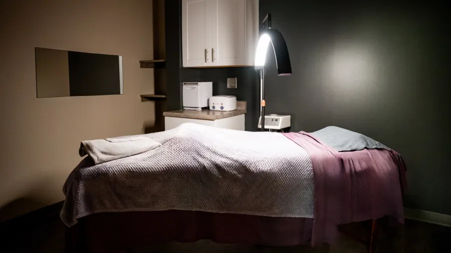 a bed with a lamp on the side