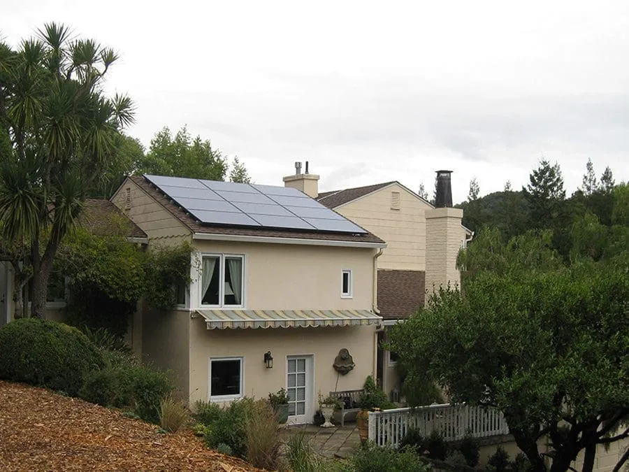 a house with trees and bushes around it