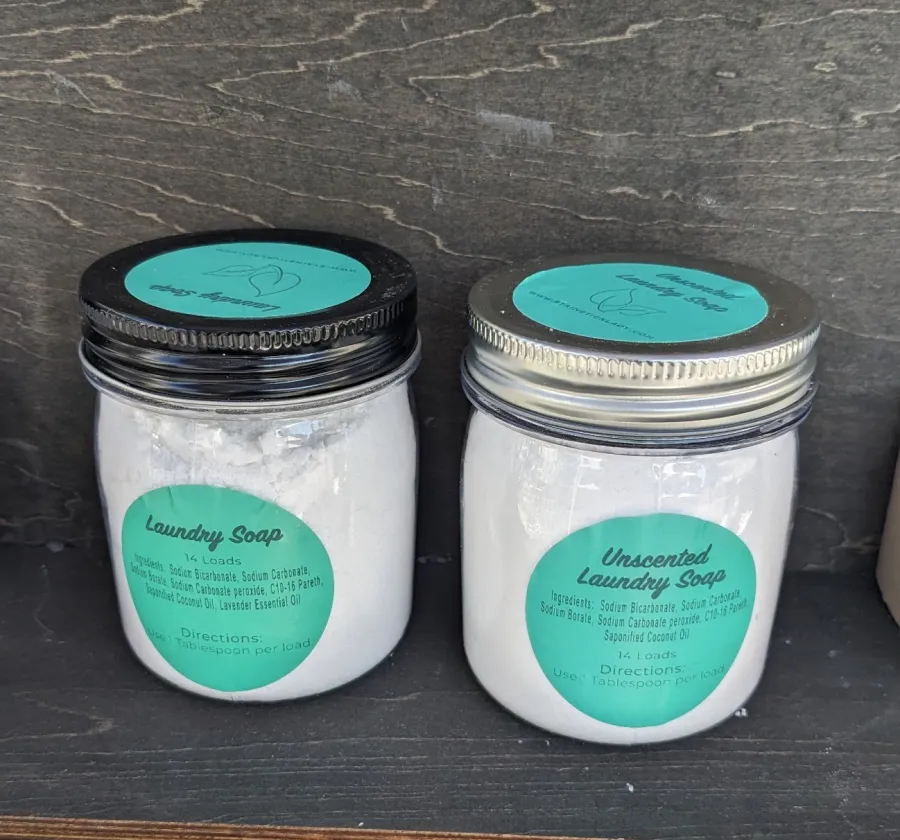 a group of powder on a laundry soap containers on wooden surface