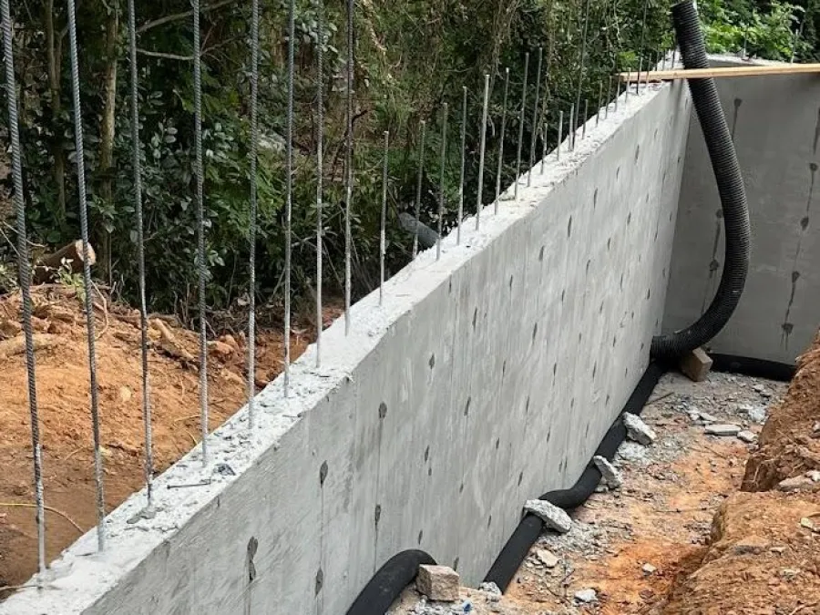 a concrete wall with a fence