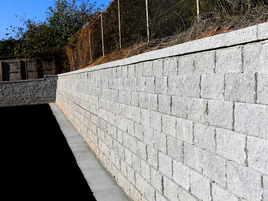 a stone wall with a fence