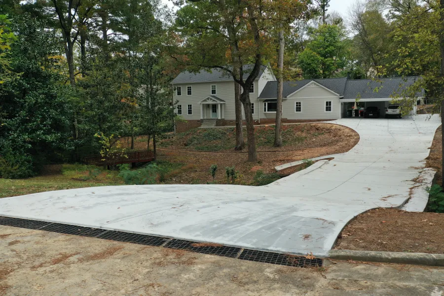 a house with a driveway and trees