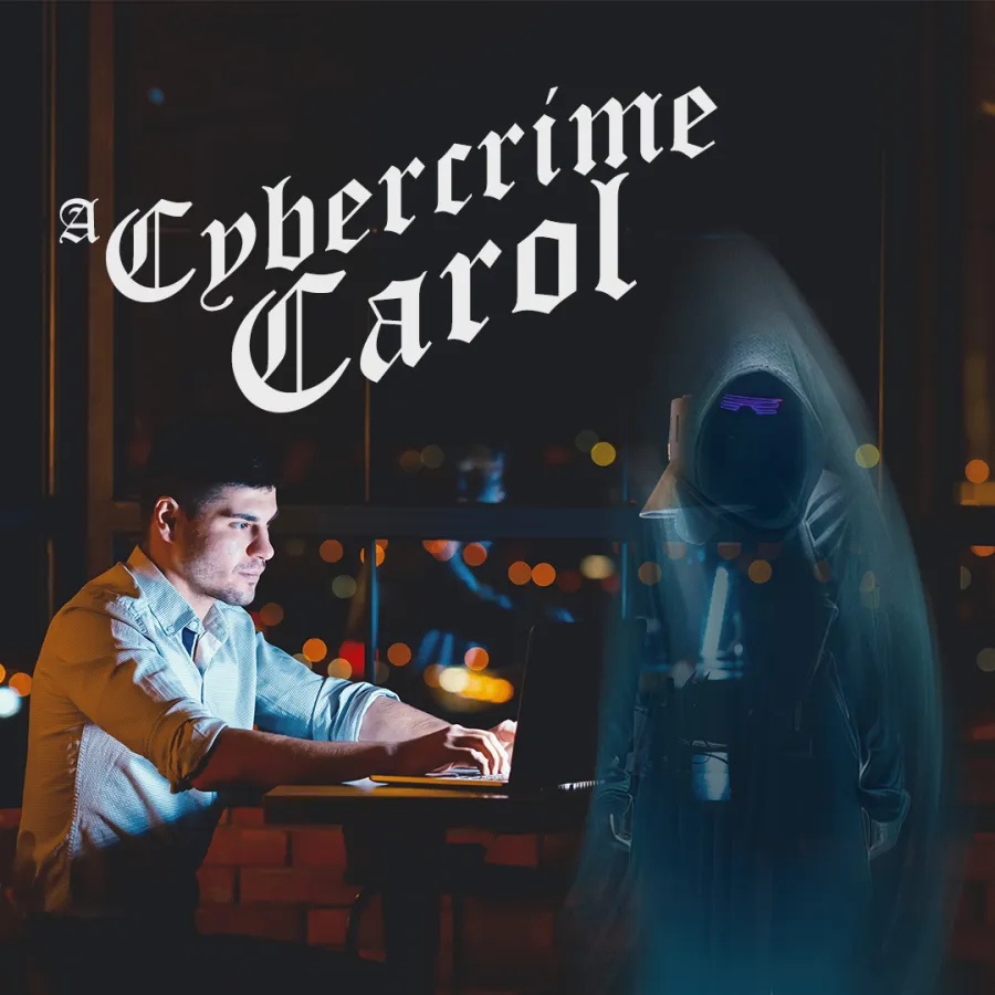 Man working on laptop in a dimly lit room with a ghostly hacker figure and Cybercrime Carol text.