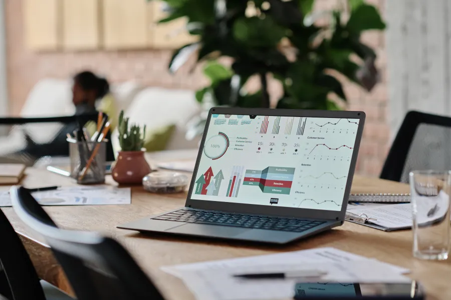 Top view of diverse business team having a meeting around a white table with documents and coffee cups.