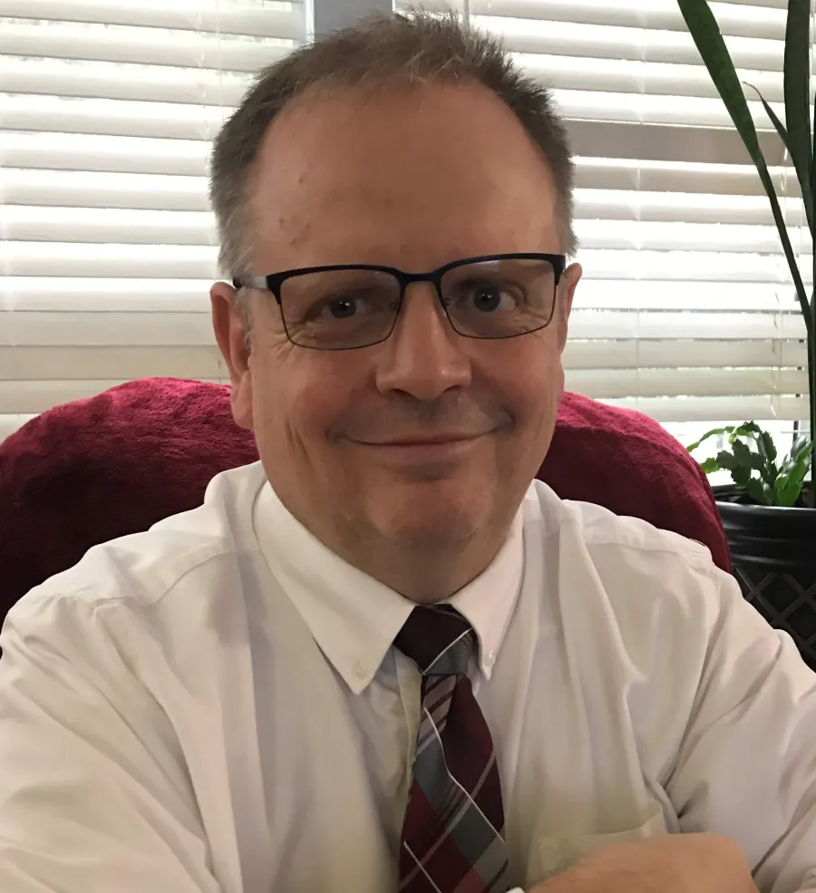 a man wearing glasses and a tie